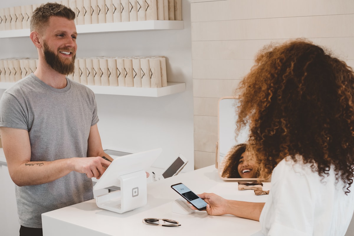 Queue of customers waiting at retail checkout counter